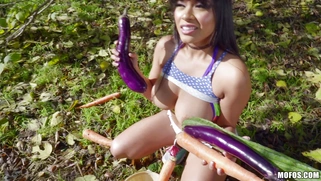 Latina Aryana Amatista plays with vegetables outdoors