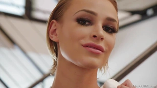 Blonde teen Emma Hix is posing on the stairs