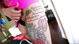Red-haired punkette Anna Bell Peaks demonstrates her tattoos