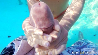 Krissy Lynn gives the lucky young man an underwater handjob