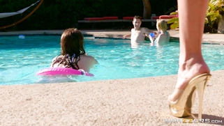 Krissy Lynn gives the lucky young man an underwater handjob