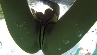 August Ames frolics in a swimming pool with her huge curves