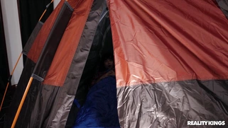 Britney Amber serves two cocks in the tent