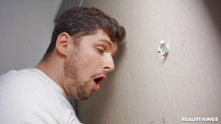 Stacy Bloom is sucking Kristof Cale's dick from the glory hole