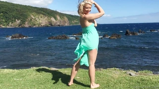 Gorgeous blonde Anikka Albrite posing among cloud-shrouded mountains