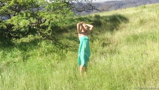 Gorgeous blonde Anikka Albrite posing among cloud-shrouded mountains