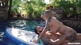 Elana Bunnz rides James Angel on the paddleboard