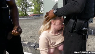Kiki Parker deepthroats two black cops on the rooftop