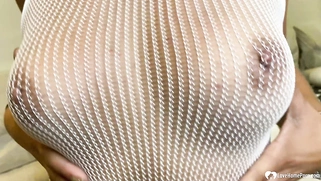 Brunette in a fishnet playing with her slit