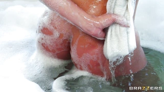 Diamond Kitty soaps down her huge tits in bubble bath