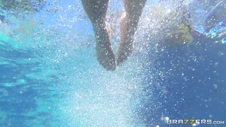 Buxom MILF Holly Halston swimming nude in the pool