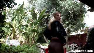 Ashley Fires posing in a tight leather pants and high heels