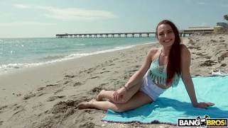 Redhead Aidra Fox has fun on the beach